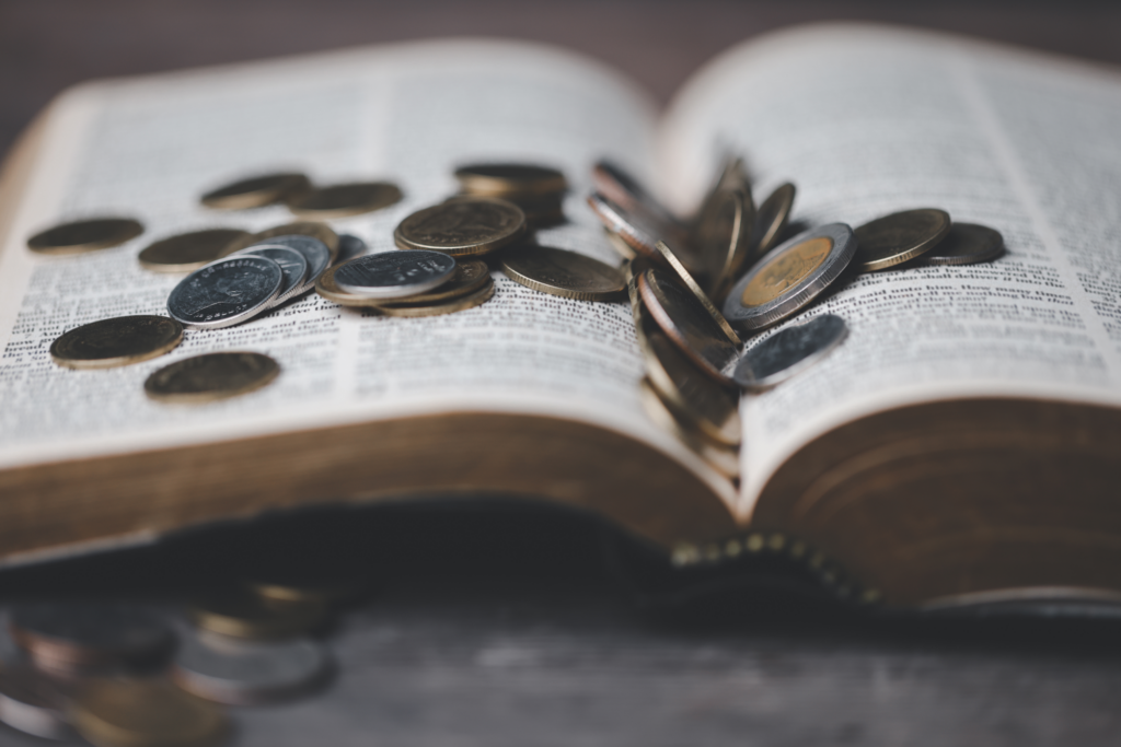 Image of a Bible with coins on it