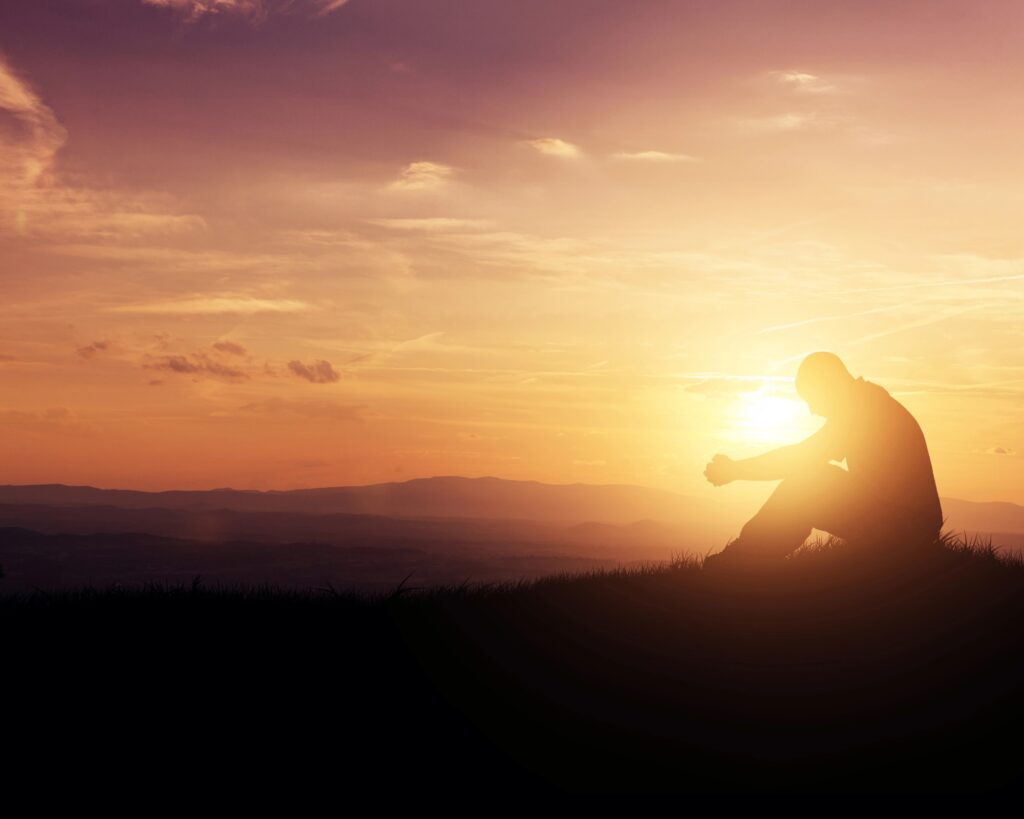 man praying silhouette